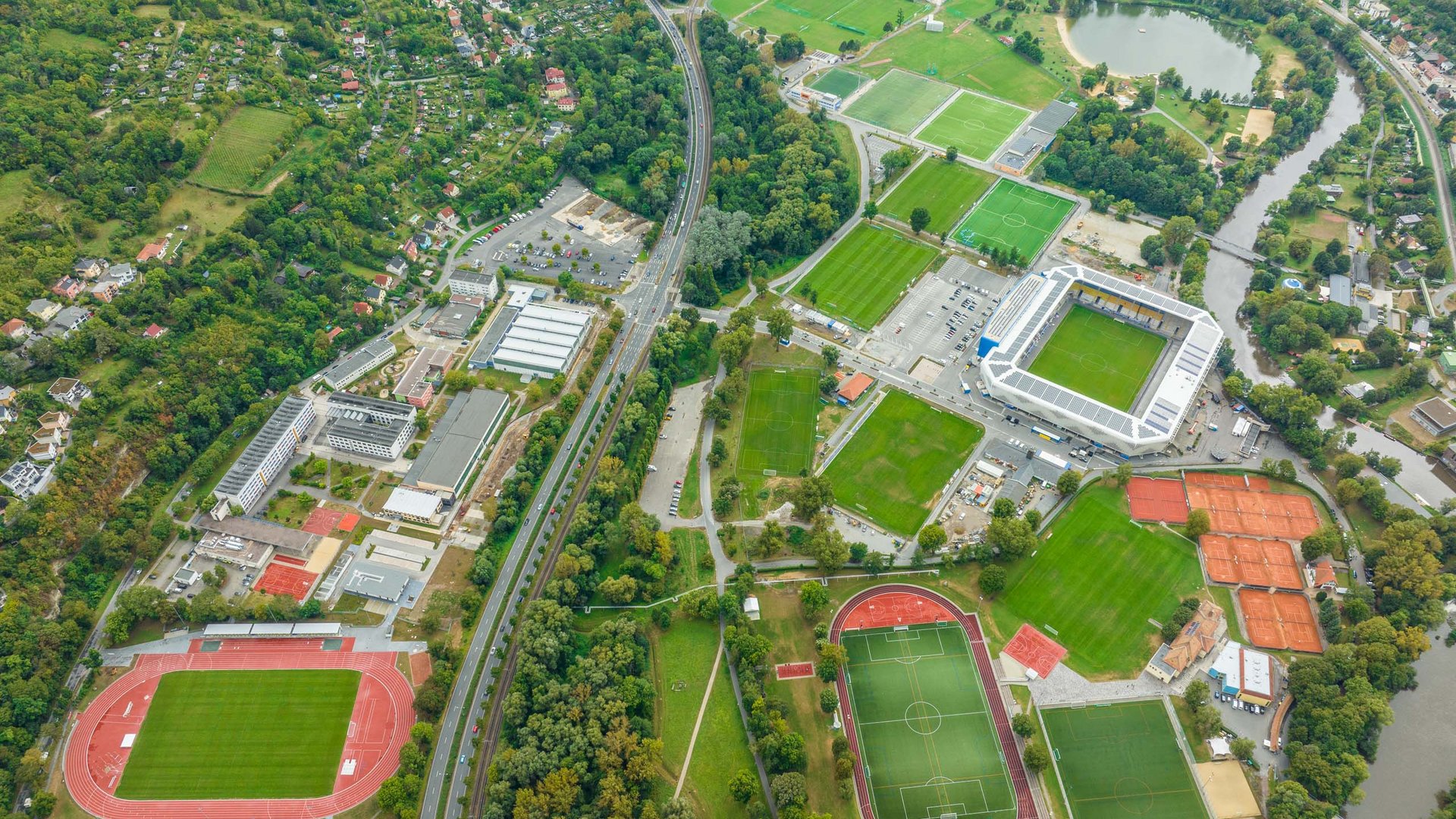 Aerial view of a large sports complex with multiple soccer fields and running tracks