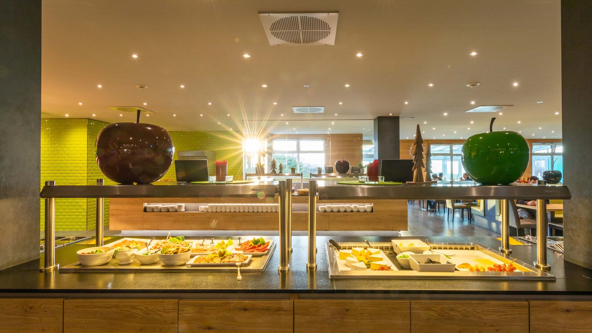Buffet with salads and cheese in modern restaurant with apple decorations